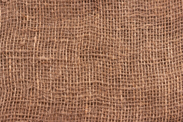 The texture of an uneven crumpled, roughly woven burlap.