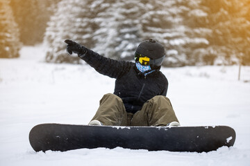 Young girl snowboarder showing something