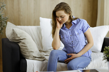 Obraz premium Tired upset woman worried about tiredness from domestic work and self isolation quarantine for COVID-19 Coronavirus. Mental health, anxiety depressed thinking young lady