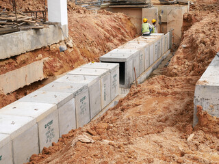 SELANGOR, MALAYSIA -JANUARY 19, 2020: Underground precast concrete box culvert drain under construction at the construction site. It is used to channel stormwater to the nearest monsoon drain.  - obrazy, fototapety, plakaty