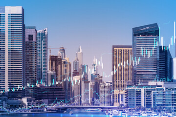 Fototapeta premium Skyscrapers of Dubai business downtown. International hub of trading and financial services of Western Asia. FOREX graph and chart concept. Double exposure. Dubai Canal waterfront.