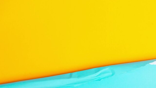 4k-Stop motion blue paper transform on yellow background.