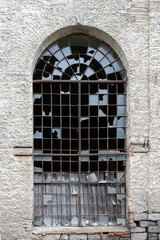 windows of an old abandoned factory. Broken glass in an old building