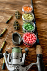 Accessories for carp fishing and fishing baits on wooden planks with copy space