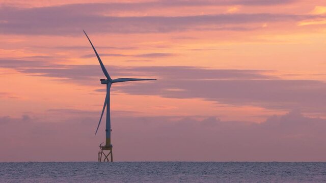 Offshore wind turbine at sunrise