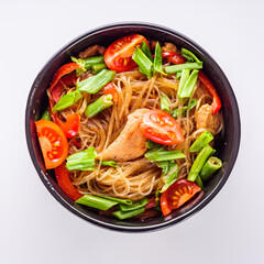 delicious glass noodles with chicken and vegetables on a white acrylic background