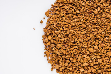 instant coffee granules on a white acrylic background
