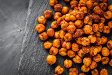 fried chickpeas on a dark stone background