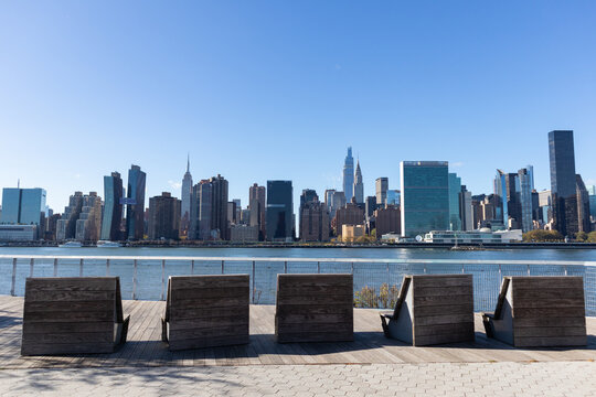 Empty Lounge Chairs along the Riverfront of Long Island City Queens New York with the Midtown Manhattan Skyline