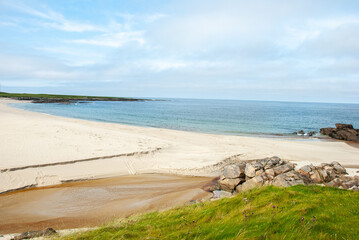 White sandy beach on the shore of  the Atlantic Ocean on Barra Island, in the Outer Hebrides, Scotland, UK