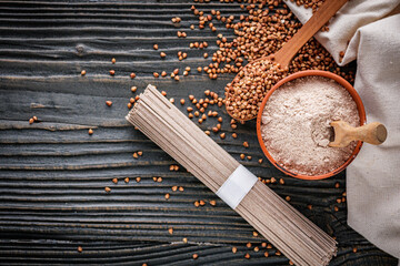fresh natural buckwheat flour on a dark wooden rustic background culinary concept