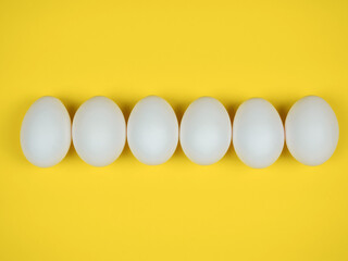 White eggs on a yellow background.
