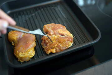 Spiced chicken thighs in a grill pan
