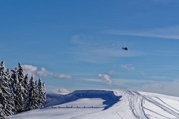 ski resort in winter with a helicopter in the distance