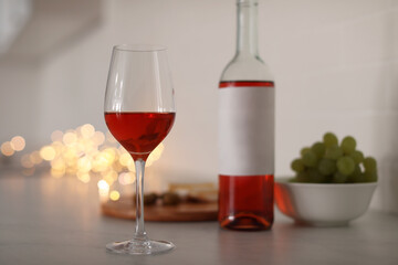 Glass of delicious wine on table, space for text. Bokeh effect