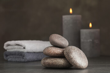 Stack of spa stones on grey table, closeup