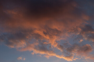 Fototapeta na wymiar dark cloud sky illuminated red setting sun