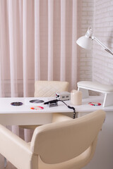 Working place for nail care master in beauty salon. Modern design and interior.