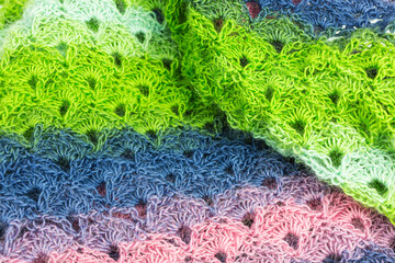 handmade multicolor crochet background in green, blue and pink with double crochet stitches