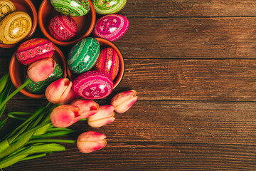 Colorful Easter eggs on wooden background. Happy Easter. Space for text.