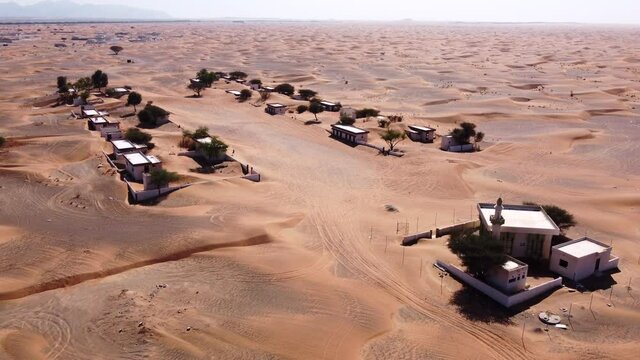Aerial flying over village of Al Madam ghost town on sunny day