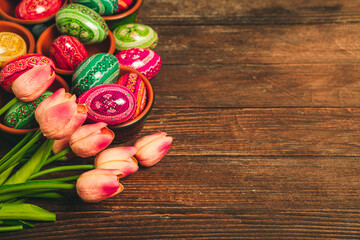Fototapeta na wymiar Colorful Easter eggs on wooden background. Happy Easter. Space for text.