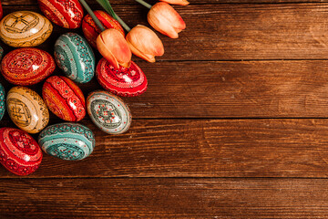 Colorful Easter eggs on wooden background. Happy Easter. Space for text.
