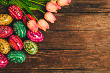 Colorful Easter eggs on wooden background. Happy Easter. Space for text.
