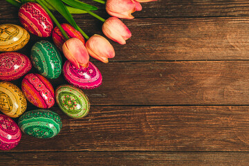 Obraz na płótnie Canvas Colorful Easter eggs on wooden background. Happy Easter. Space for text.