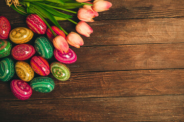Colorful Easter eggs on wooden background. Happy Easter. Space for text.