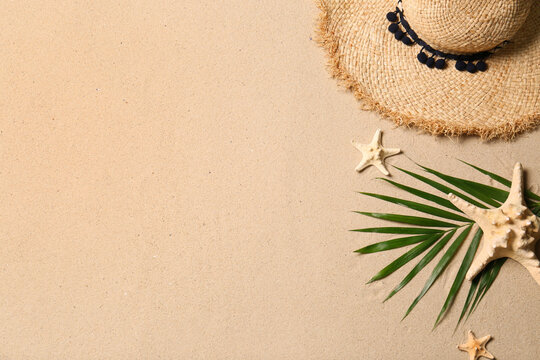 Straw Hat, Palm Leaf, Starfishes And Space For Text On Beach Sand, Flat Lay. Summer Vacation