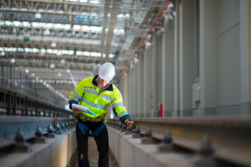 Inspector (Engineer) checking railway or track in depot of train