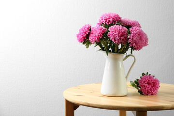 Bouquet of beautiful asters on table, space for text. Autumn flowers