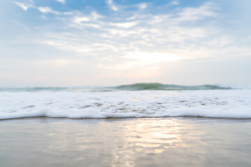 Fototapeta na wymiar Soft wave of the tropical sea on the sandy beach.