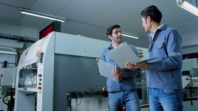 specialist worker engineer team control and operate printing package lable machine with computer screen with concentrate and focus industrial factory machinery ideas concept