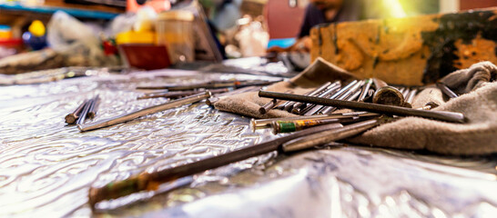 Silvermaker. Silversmiths tools on the silver workplace.