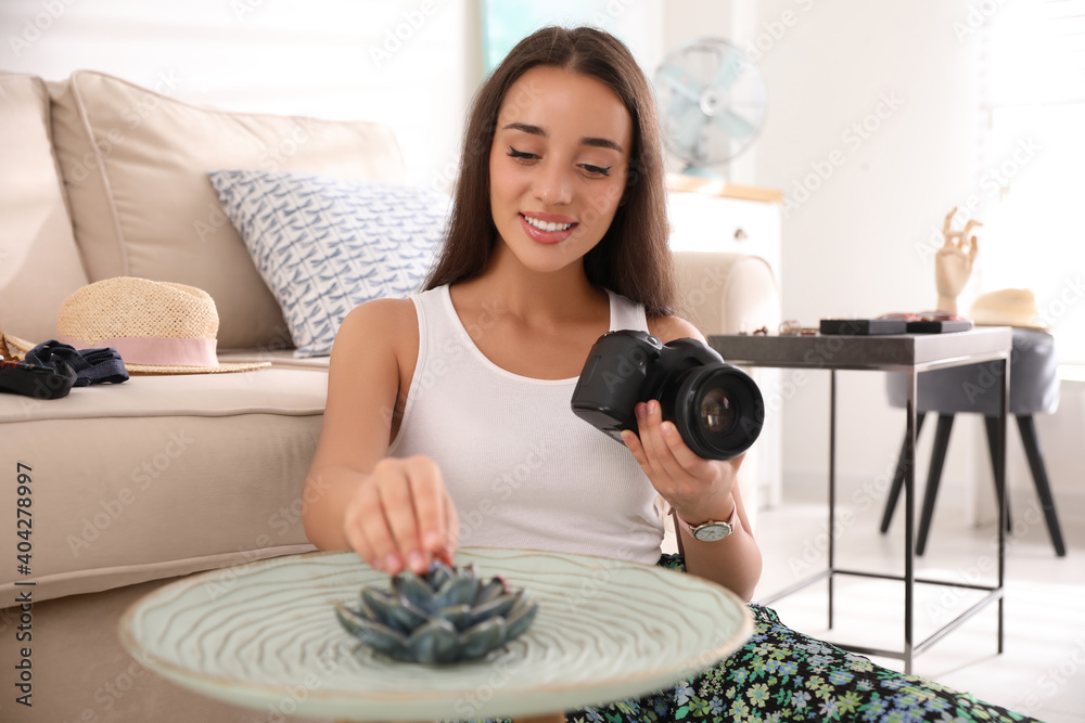 Poster Young photographer taking picture of jewelry indoors