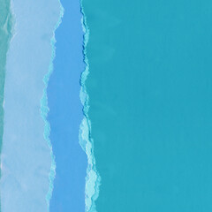 Blue torn paper collage close-up. Texture made from various paper and cardboard parts. Damaged old paper background. Vintage blank wallpaper. Material design backdrop.