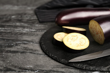 Fresh eggplants on grey table, closeup. Space for text