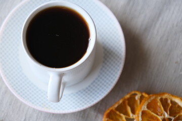 Turkish coffee with mandarin slices.