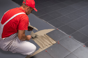 Floor ceramic tiles installation. Create, arranging.