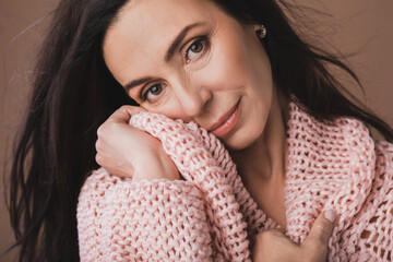 Portrait of beautiful middle aged woman wearing warm woolen sweater