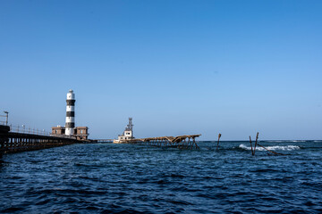 Fototapeta na wymiar vintage pier and lighthouse in the Red Sea on a sunny day