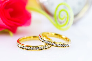 Two golden wedding rings and branch flowers