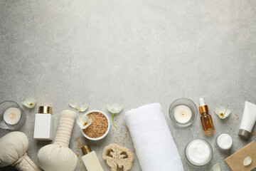 Fototapeta na wymiar Flat lay spa composition with skin care products on grey table, space for text