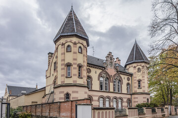 Fragments of old building of Circle Catholic Saint-Martin, created in 1880 - 72-meter-long building combines neo-Romanesque and neo-gothic styles. Colmar, Alsace, France.