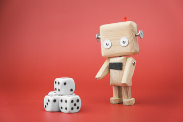 wooden robot next to the dice, on a red background. gambling concept