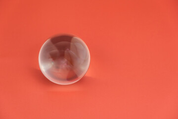 transparent glass ball on a safe background. empty space on the right