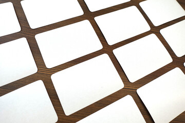 Mockup of a deck of playing cards. Blank white cards for design on wooden table
