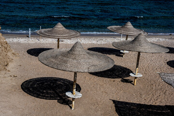 view of a deserted beach on a sunny day with sea and blue sky